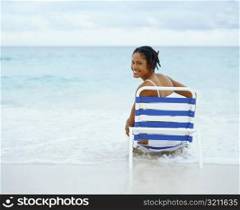 Portrait of a young woman sitting on a lounge chair, Bermuda