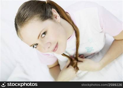 Portrait of a young woman sitting on the bed