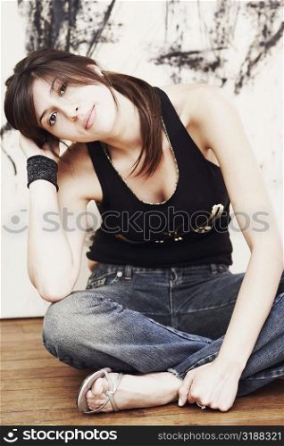 Portrait of a young woman sitting on the floor