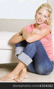 Portrait of a young woman sitting on the floor