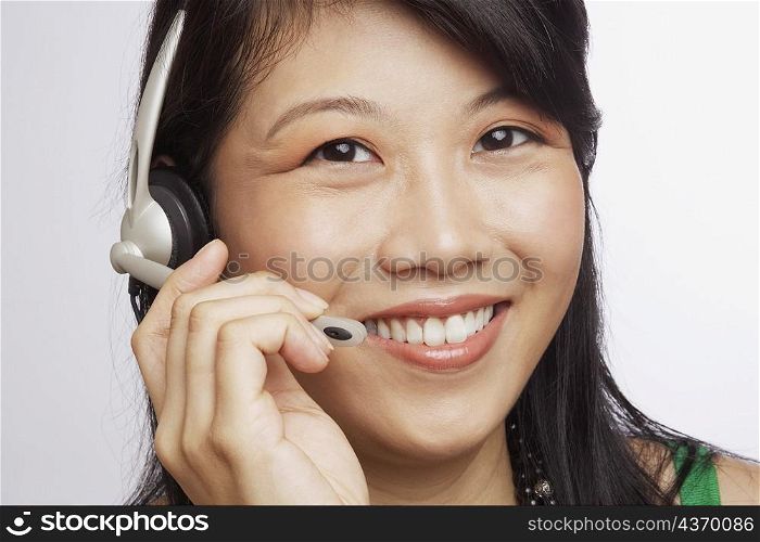 Portrait of a young woman smiling and wearing a headset