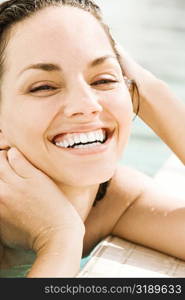 Portrait of a young woman smiling at the poolside