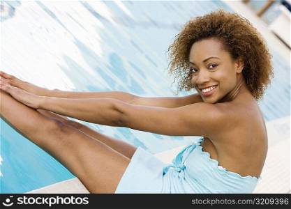 Portrait of a young woman smiling at the poolside