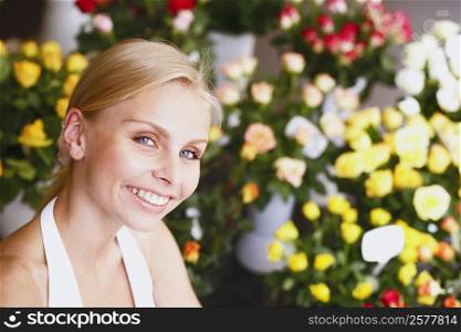 Portrait of a young woman smiling in a flower shop