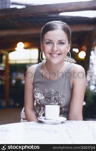 Portrait of a young woman smiling in a restaurant