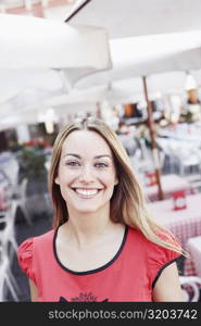 Portrait of a young woman smiling in a restaurant