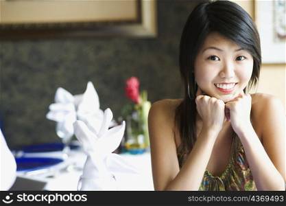 Portrait of a young woman smiling in a restaurant