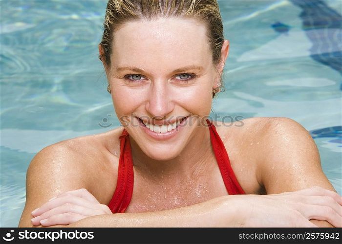 Portrait of a young woman smiling in a swimming pool