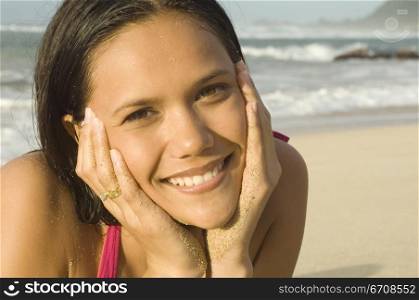 Portrait of a young woman smiling on the beach