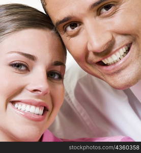 Portrait of a young woman smiling with a mid adult man