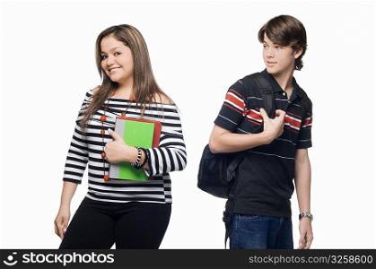 Portrait of a young woman smiling with a teenage boy looking at her