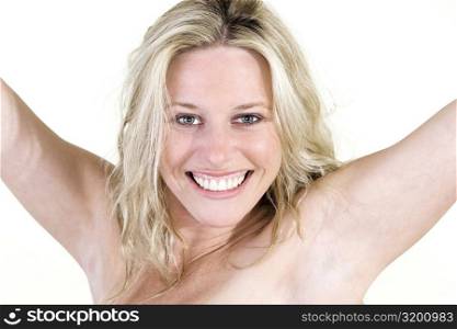 Portrait of a young woman smiling with her arms outstretched