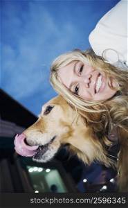 Portrait of a young woman smiling with her dog