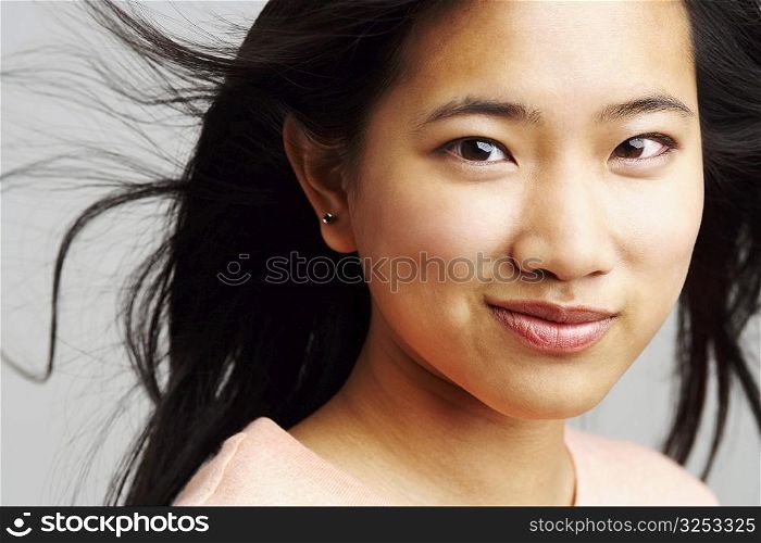 Portrait of a young woman smirking