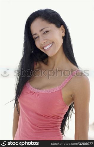 Portrait of a young woman standing and smiling