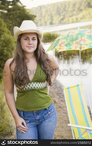 Portrait of a young woman standing at the riverside