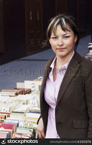 Portrait of a young woman standing in a library