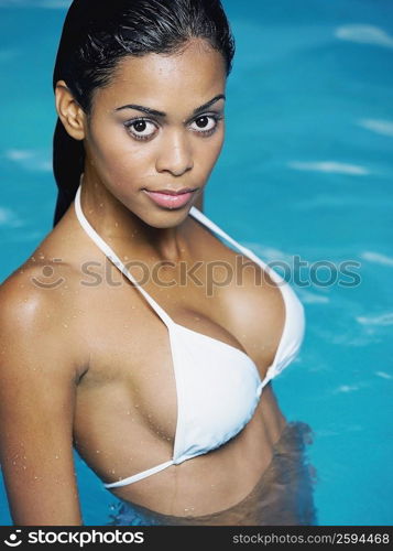 Portrait of a young woman standing in a swimming pool