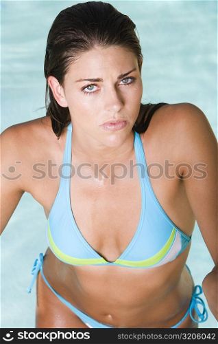 Portrait of a young woman standing in a swimming pool