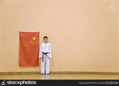 Portrait of a young woman standing near a Chinese flag