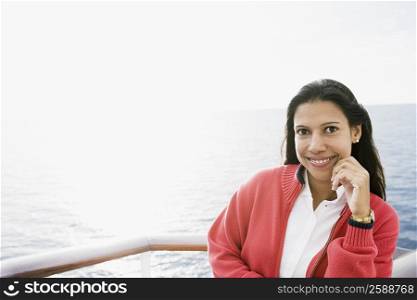 Portrait of a young woman standing on a boat deck and smiling