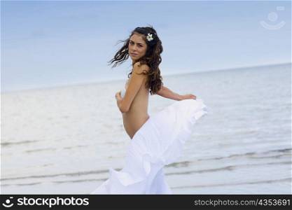 Portrait of a young woman standing on the beach