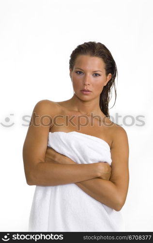 Portrait of a young woman standing with her arms crossed