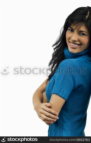 Portrait of a young woman standing with her arms crossed and smiling