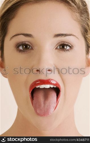 Portrait of a young woman sticking her tongue out