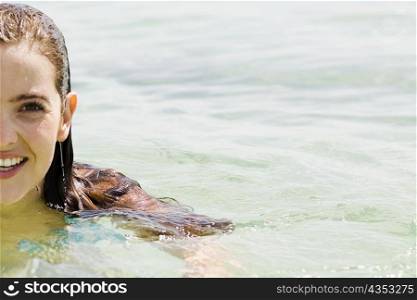 Portrait of a young woman swimming in the sea