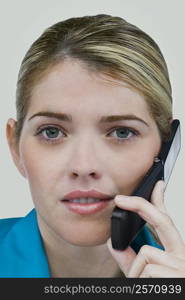 Portrait of a young woman talking on a mobile phone