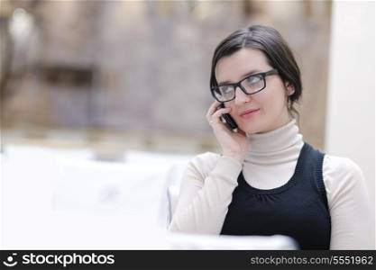 portrait of a young woman talking on a phone indoor at seminar congress room