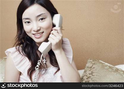 Portrait of a young woman talking on the telephone
