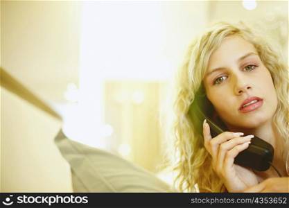 Portrait of a young woman talking on the telephone