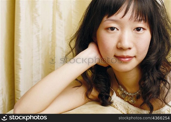 Portrait of a young woman thinking with her hands on her cheek