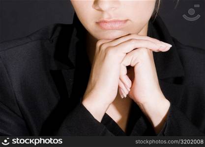 Portrait of a young woman thinking with her hands on her chin