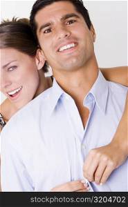 Portrait of a young woman unbuttoning a mid adult man&acute;s shirt