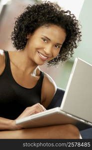 Portrait of a young woman using a laptop