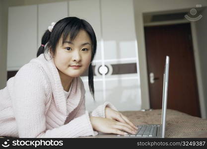 Portrait of a young woman using a laptop