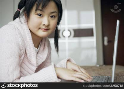 Portrait of a young woman using a laptop