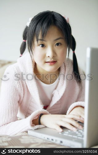 Portrait of a young woman using a laptop