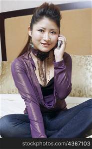 Portrait of a young woman using a mobile phone smiling
