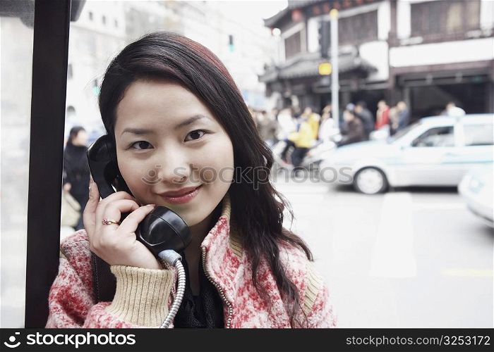 Portrait of a young woman using a telephone