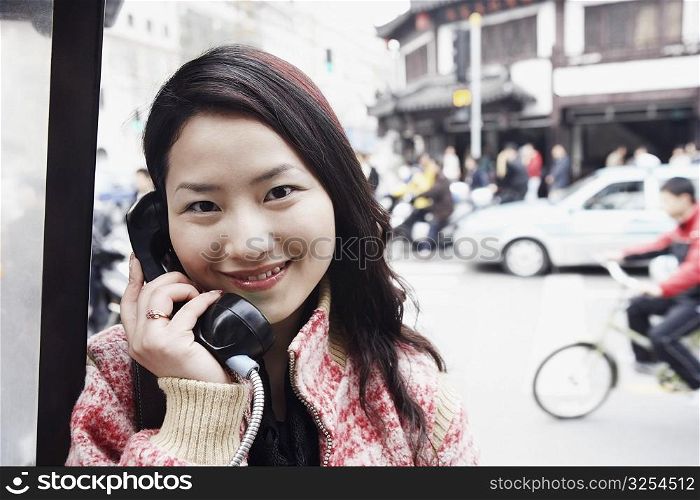 Portrait of a young woman using a telephone