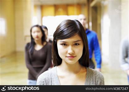Portrait of a young woman walking in the corridor