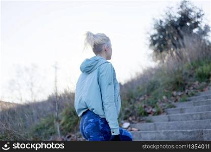Portrait of a young woman walks outdoor as workout