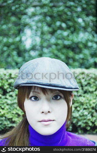 Portrait of a young woman wearing a cap
