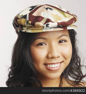 Portrait of a young woman wearing a cap and smiling