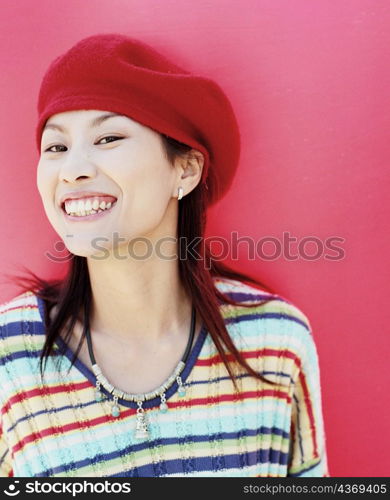Portrait of a young woman wearing a cap and smiling