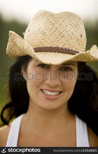 Portrait of a young woman wearing a cowboy hat